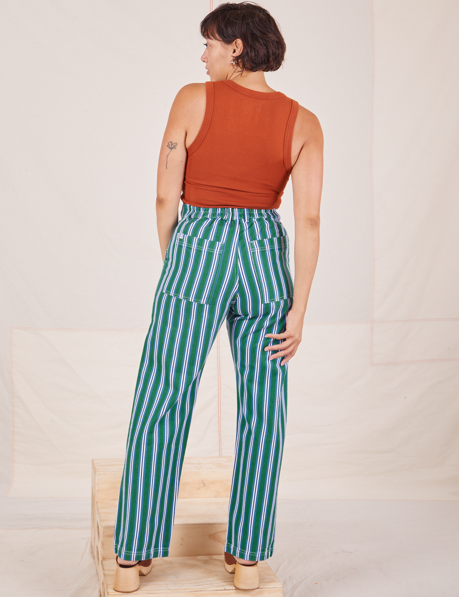 Back view of Stripe Work Pants in Green and burnt terracotta Cropped Tank worn by Tiara