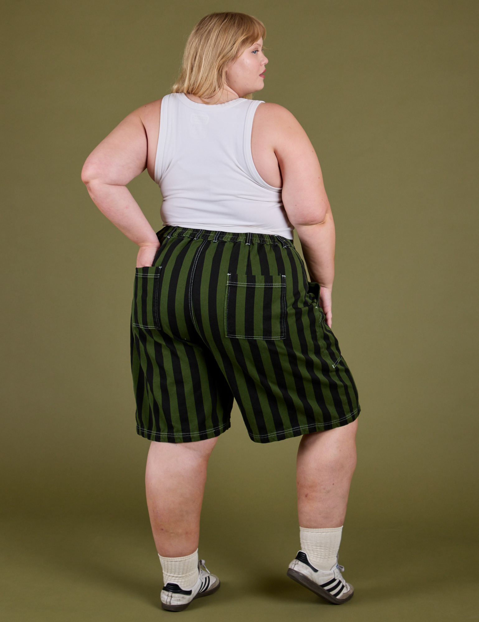 Back view of Longline Work Shorts in Evergreen and vintage tee white Cropped Tank on Juliet