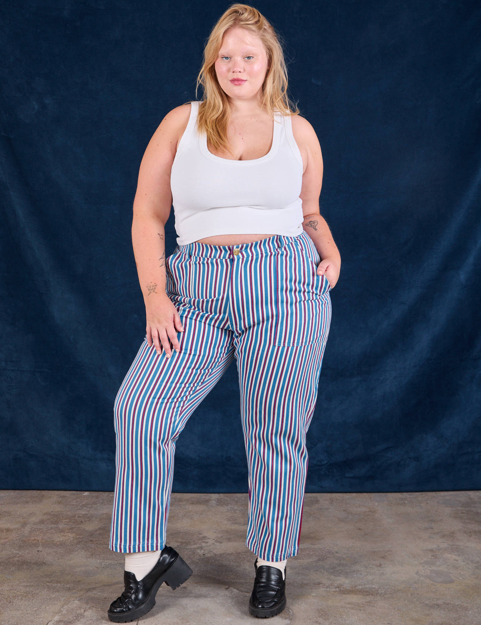 Juliet is 5&#39;7&quot; and wearing 1XL Stripe Work Pants in Blue Raspberry paired with a Cropped Tank in vintage tee off-white