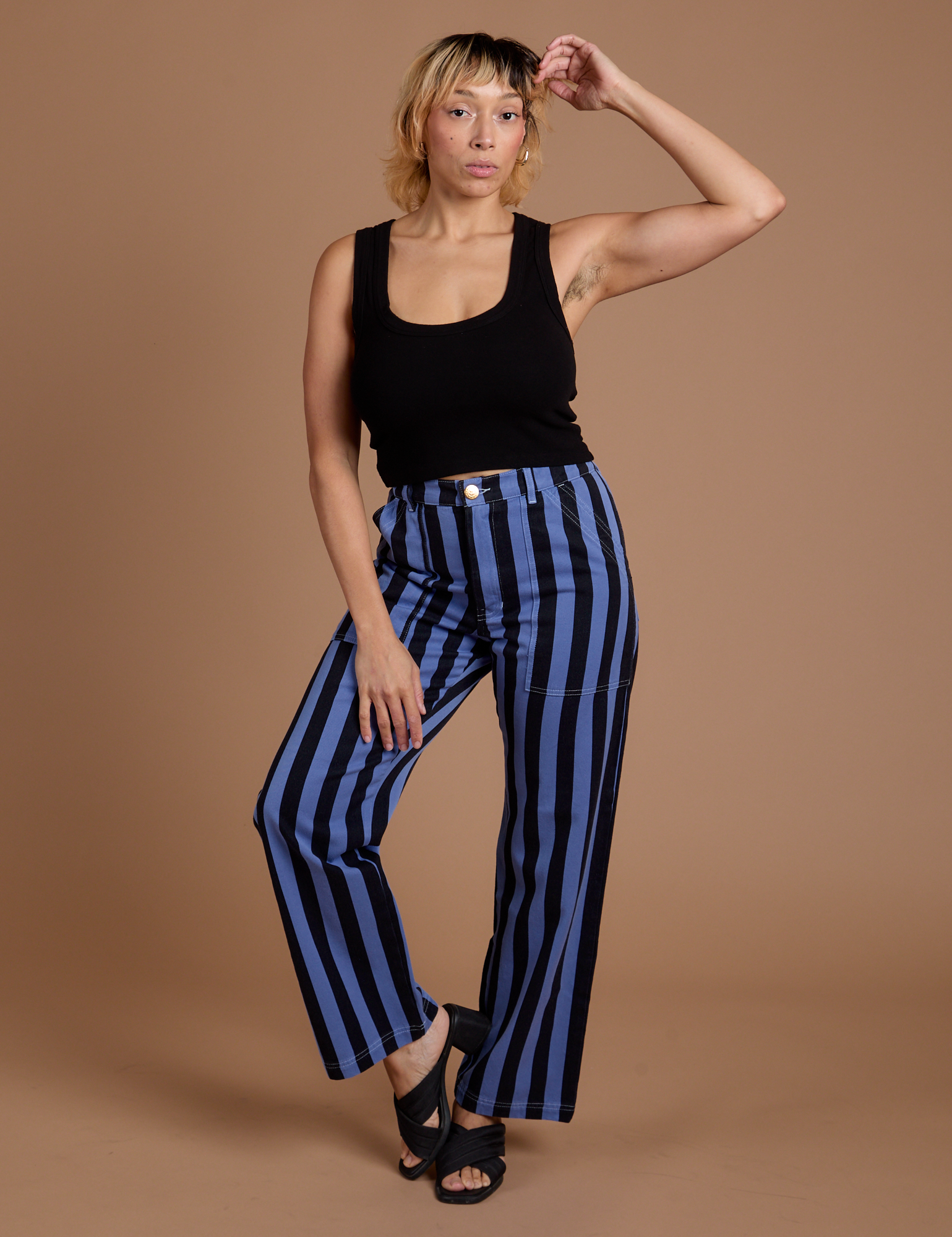 Tiara is 5’4” and wearing S Black Stripe Work Pants in Cornflower Blue
