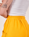 Cropped Rolled Cuff Sweatpants in Mustard Yellow elastic waist band close up on Alex