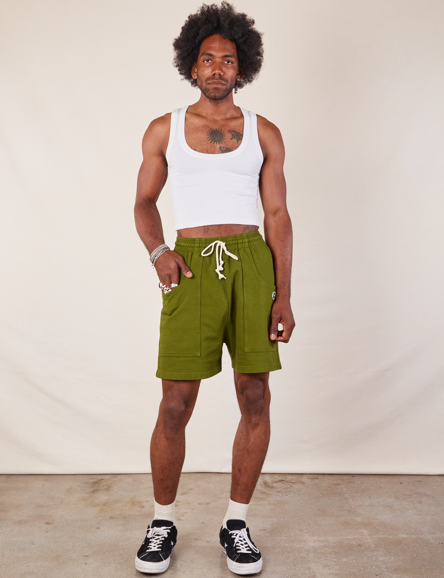 Jerrod is 6’3” and wearing S Lightweight Sweat Shorts in Summer Olive paired with a Cropped Tank in vintage tee off-white