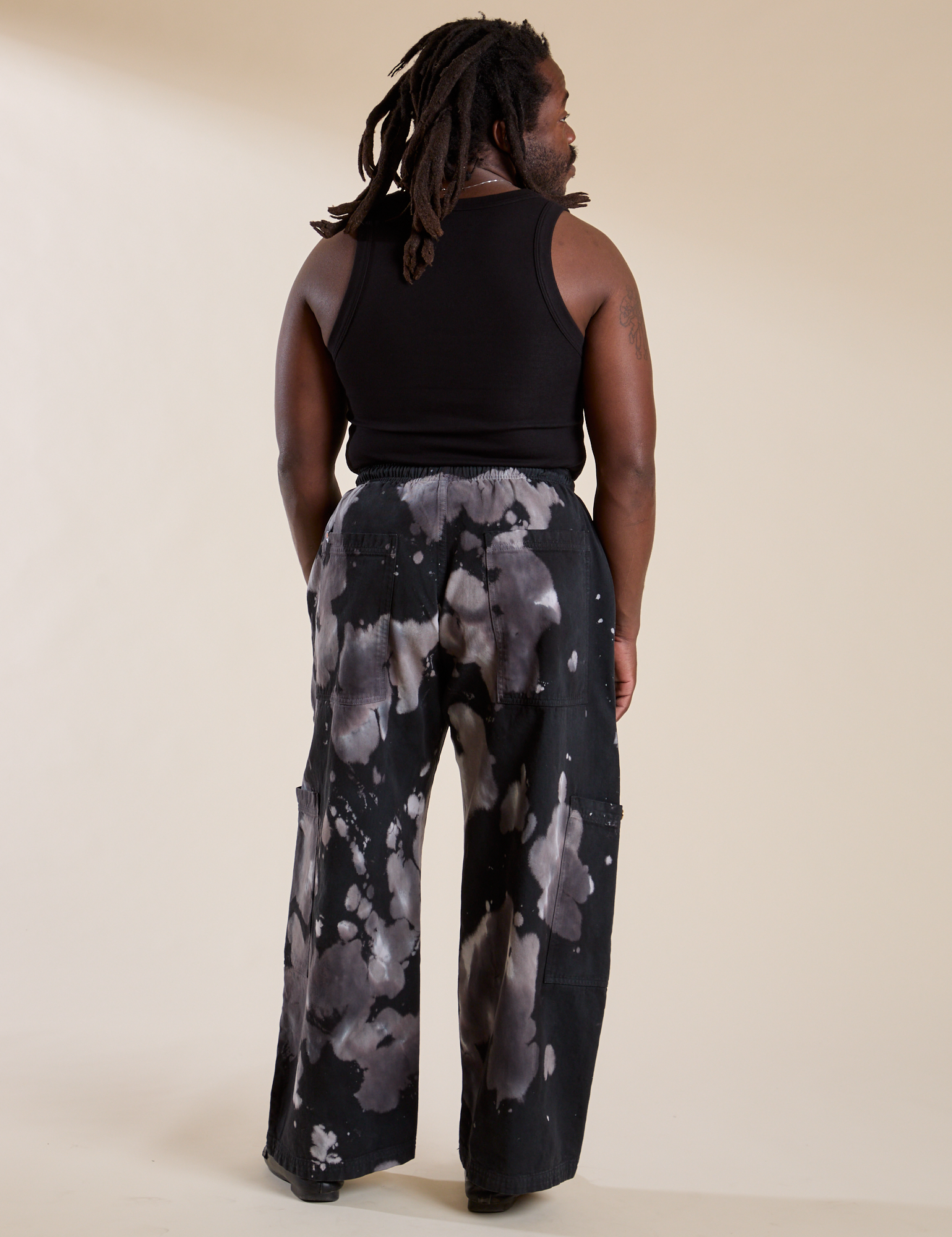 Back view of Magic Waters Drop Pocket Pants in Ink Blot and black Cropped Tank on Demi