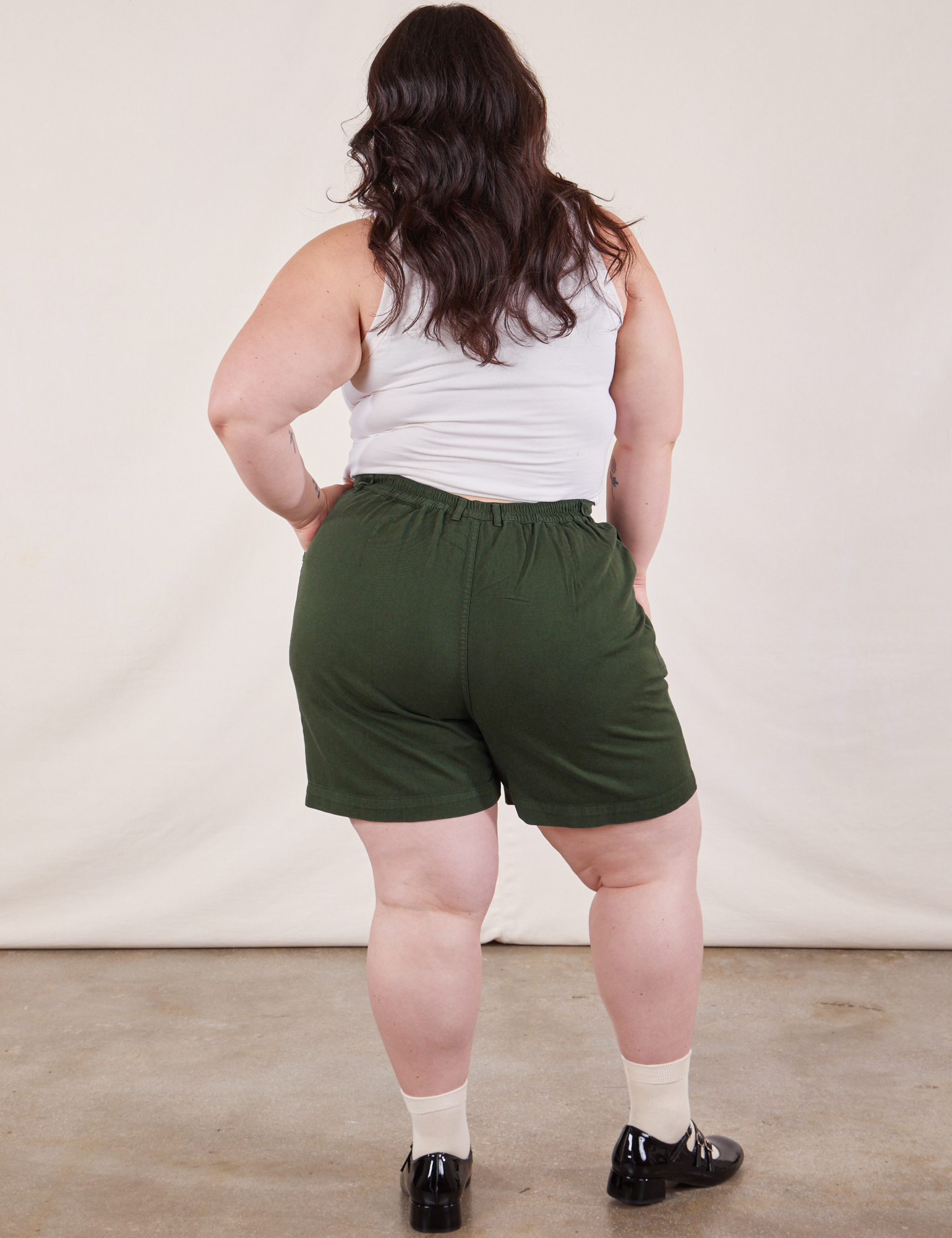 Back view of Trouser Shorts in Swamp Green and Cropped Tank in Vintage Tee Off-White on Ashley