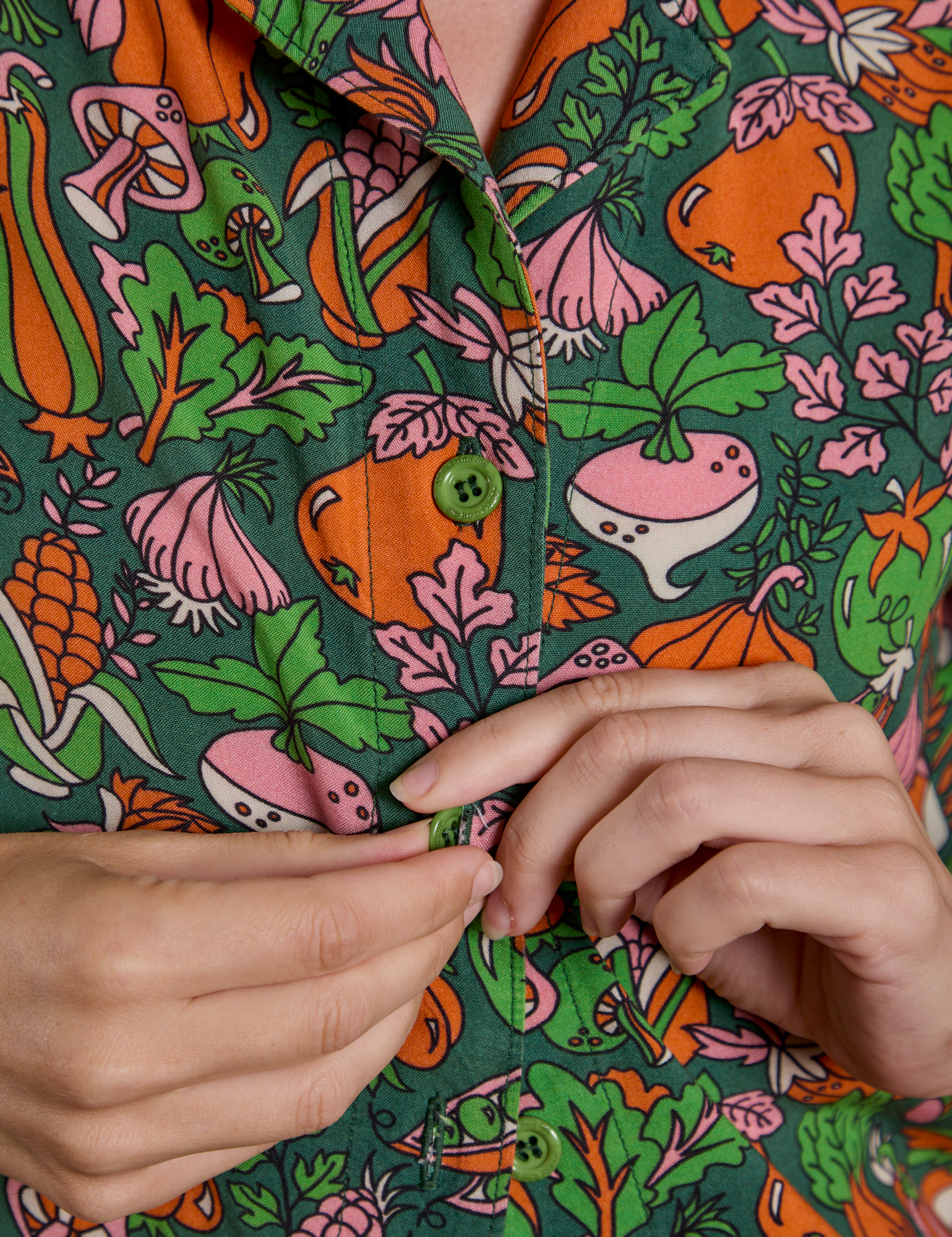 Close up of Alex buttoning the Kitchen Collection Pantry Button-Up