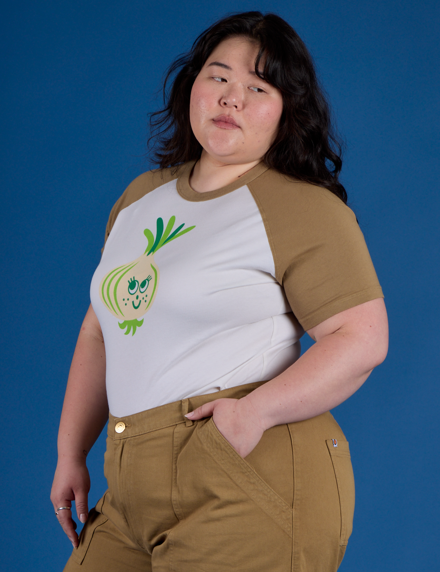 Angled front view of Produce Raglan Tee in Onion on Ashley