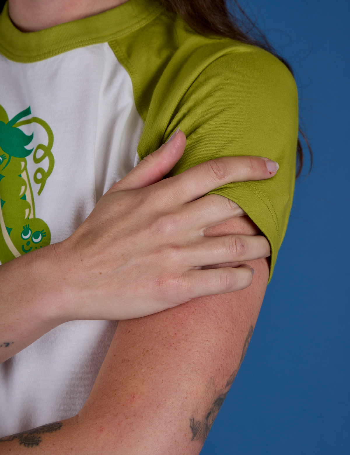 Produce Raglan Tee in Snap Peas sleeve close up on Alex