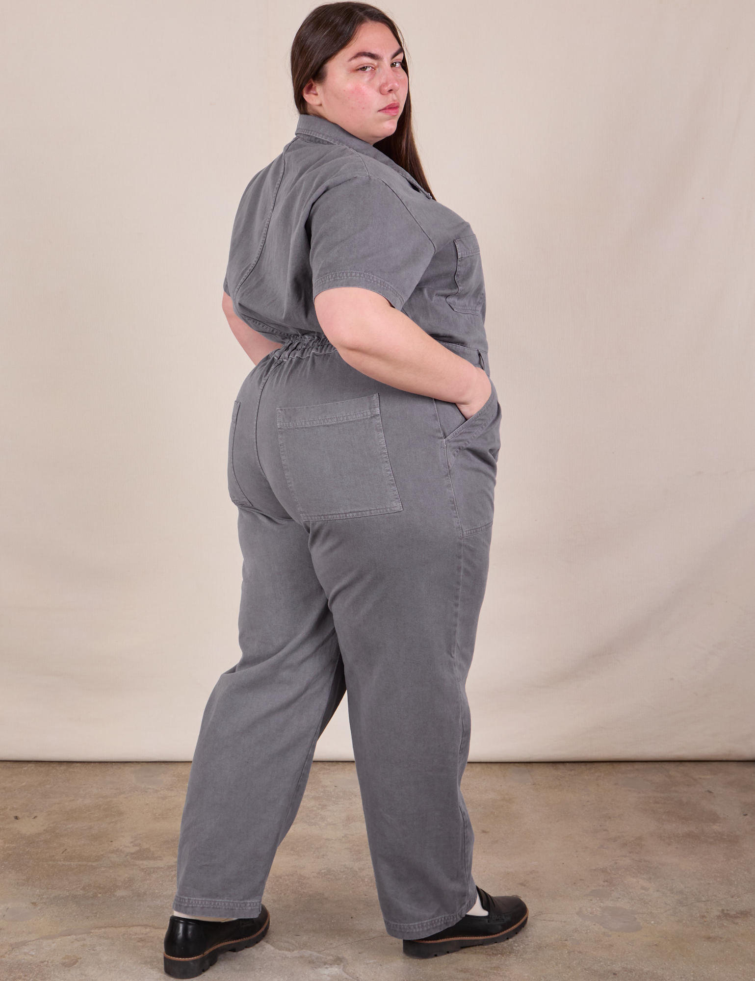 Angled back view of Short Sleeve Jumpsuit in Washed Grey on Marielena