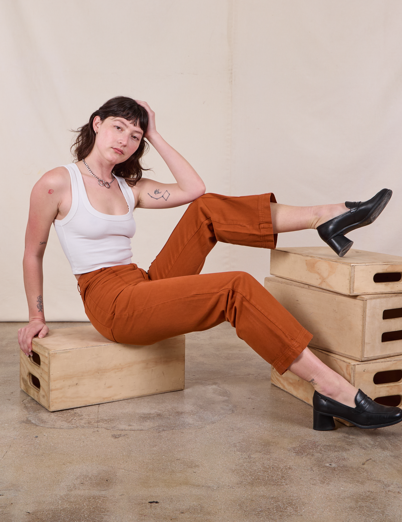 Western Pants in Burnt Terracotta and Cropped tank in Vintage Tee Off-White worn by Alex