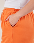 Wide Leg Sweat Pants in Sunset Orange side pocket close up on Ryan