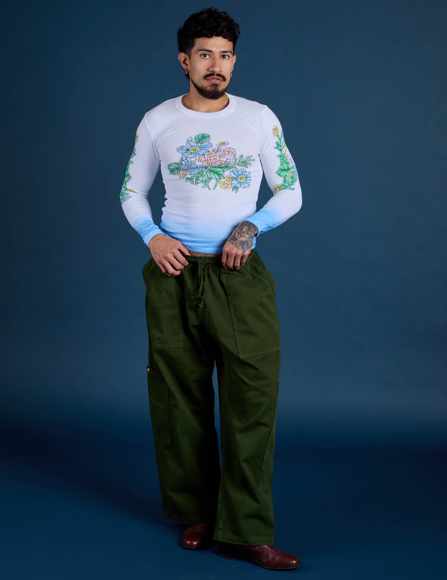 Jesse is wearing Floral Long Sleeve Baby Tee in Baby Blue and evergreen Drop Pocket Cargo Pants