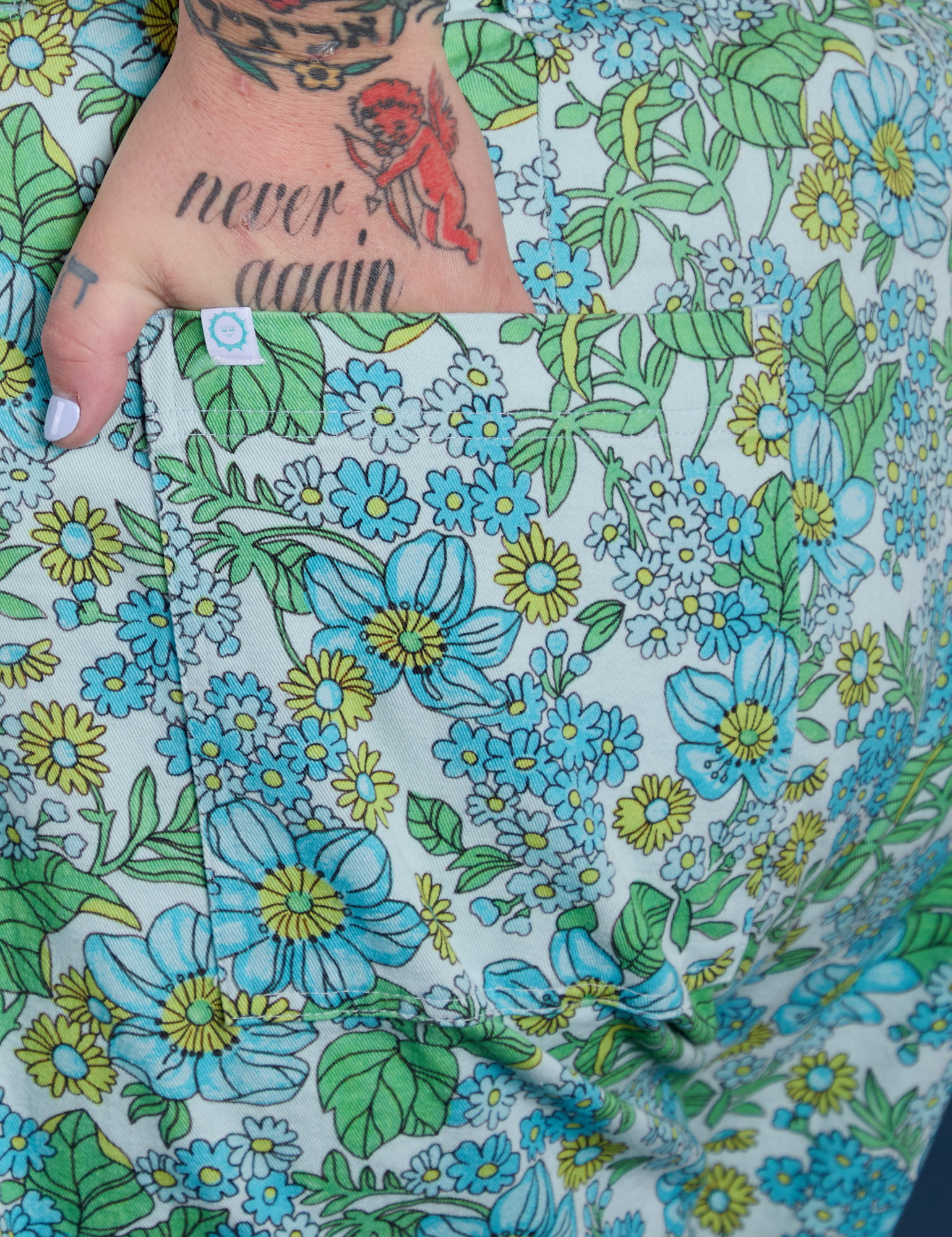 Close up of Sam's hand in the back pocket of Winter Floral Print Work Pants