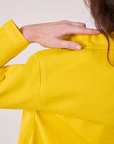 Back shoulder close up of Denim Work Jacket in Golden Yellow on Alex