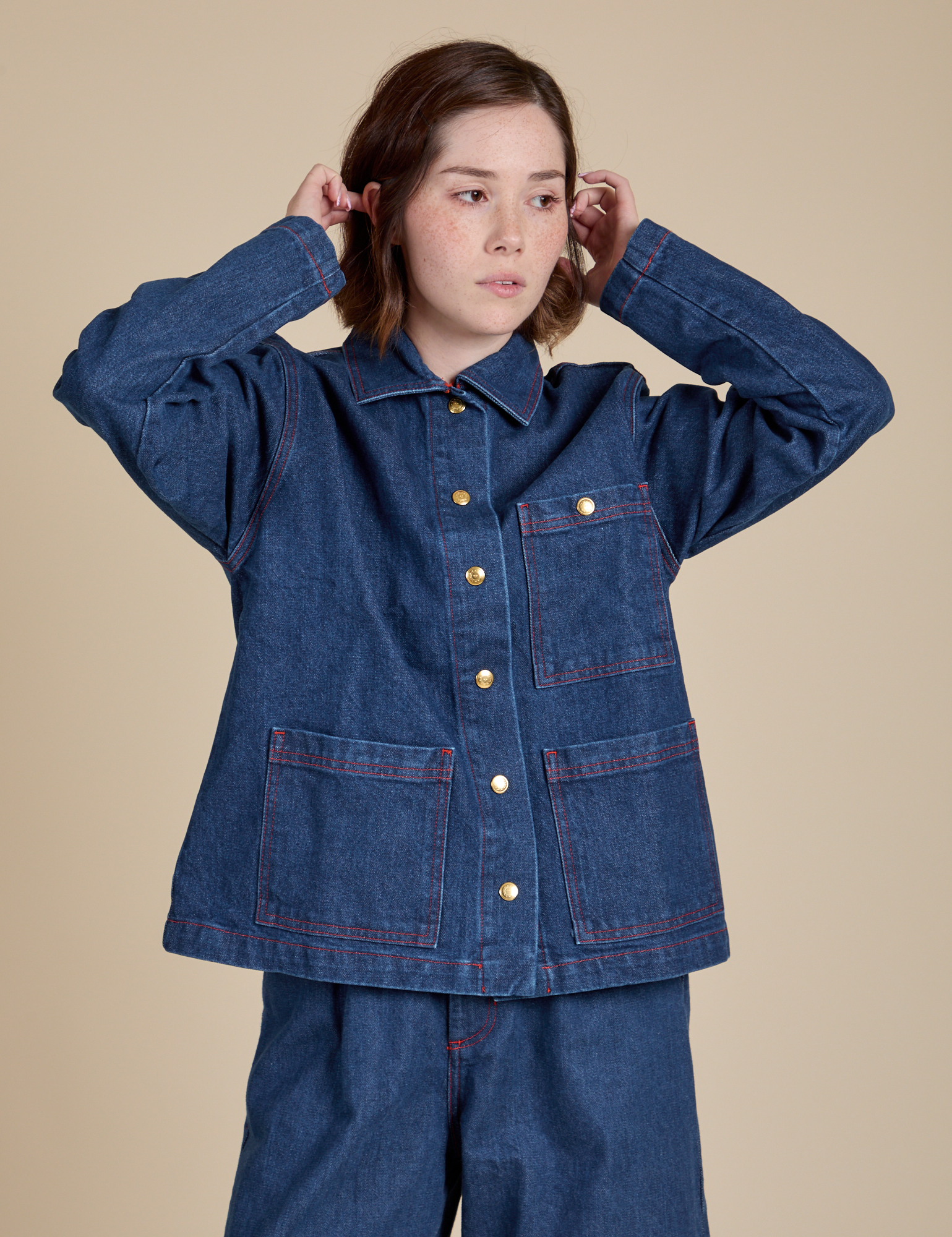 Hana is wearing a buttoned up Indigo Denim Work Jacket in Dark Wash