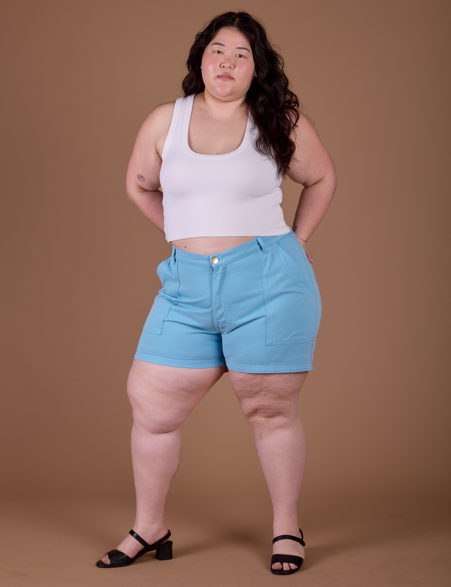 Ashley is 5’7” and wearing 1XL Classic Work Shorts in Baby Blue paired with vintage off white Cropped Tank