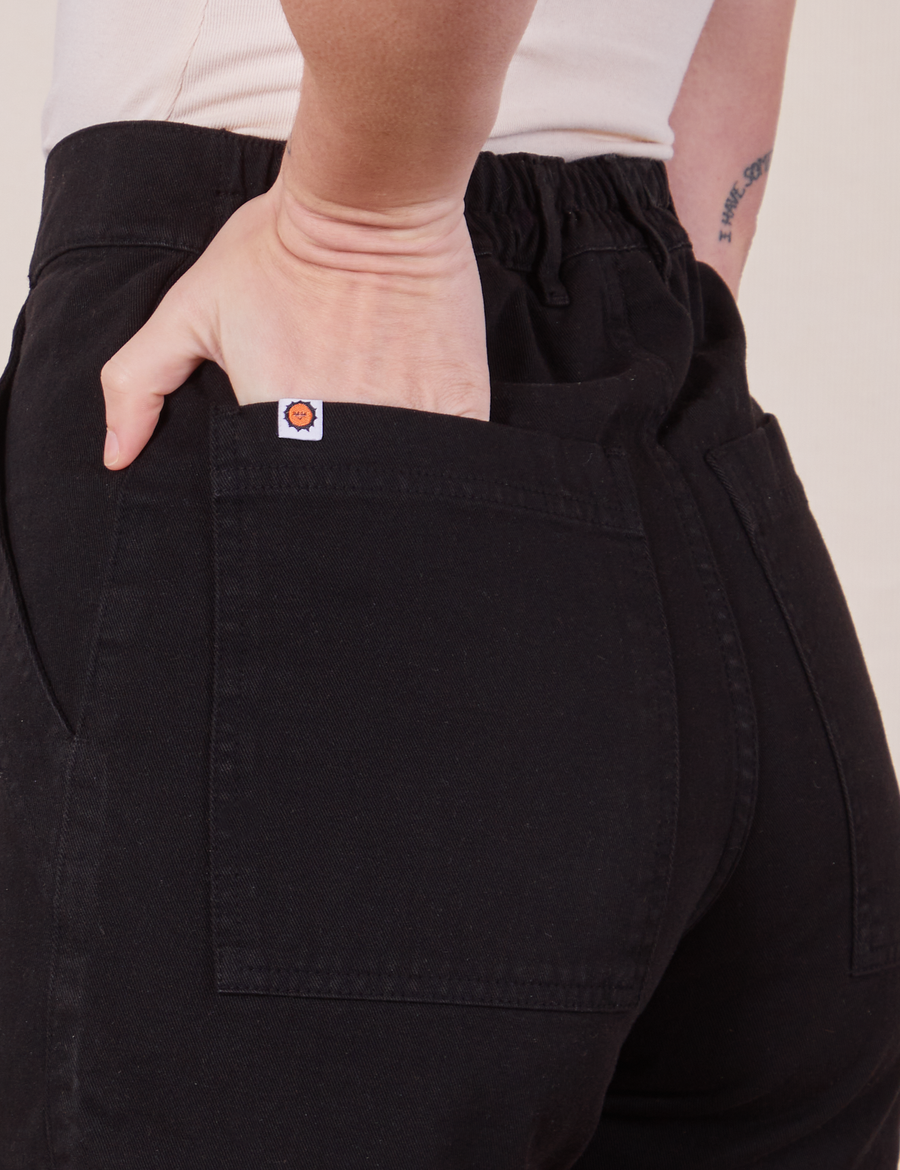 Back close up of Classic Work Shorts in Basic Black. Alex has her hand in the pocket
