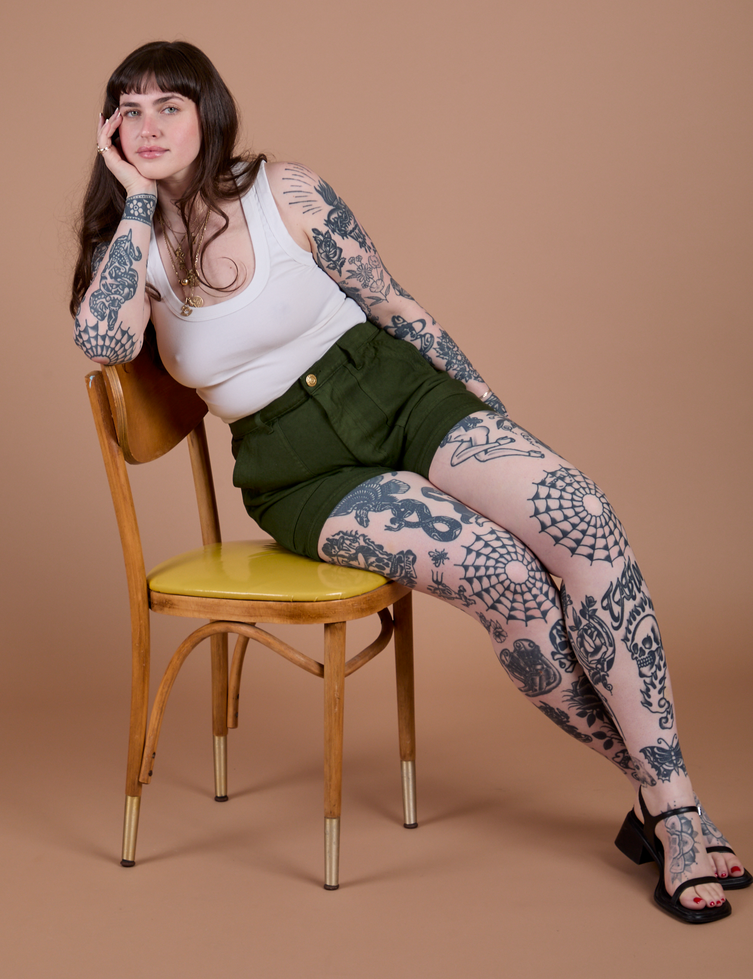 Sydney is wearing Classic Work Shorts in Evergreen and Cropped Tank in Vintage Tee White