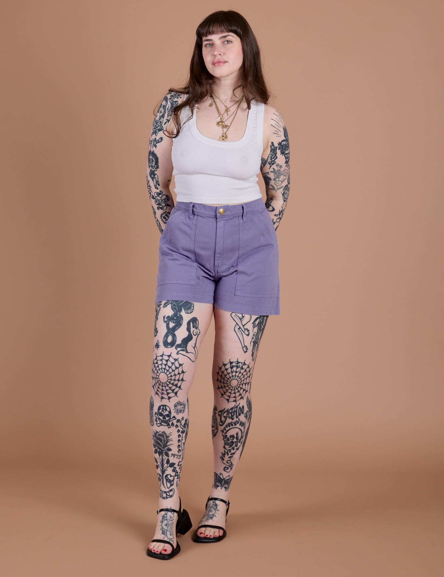 Sydney is 5’9” and wearing M Classic Work Shorts in Faded Grape paired with a Cropped Tank in Vintage Tee White