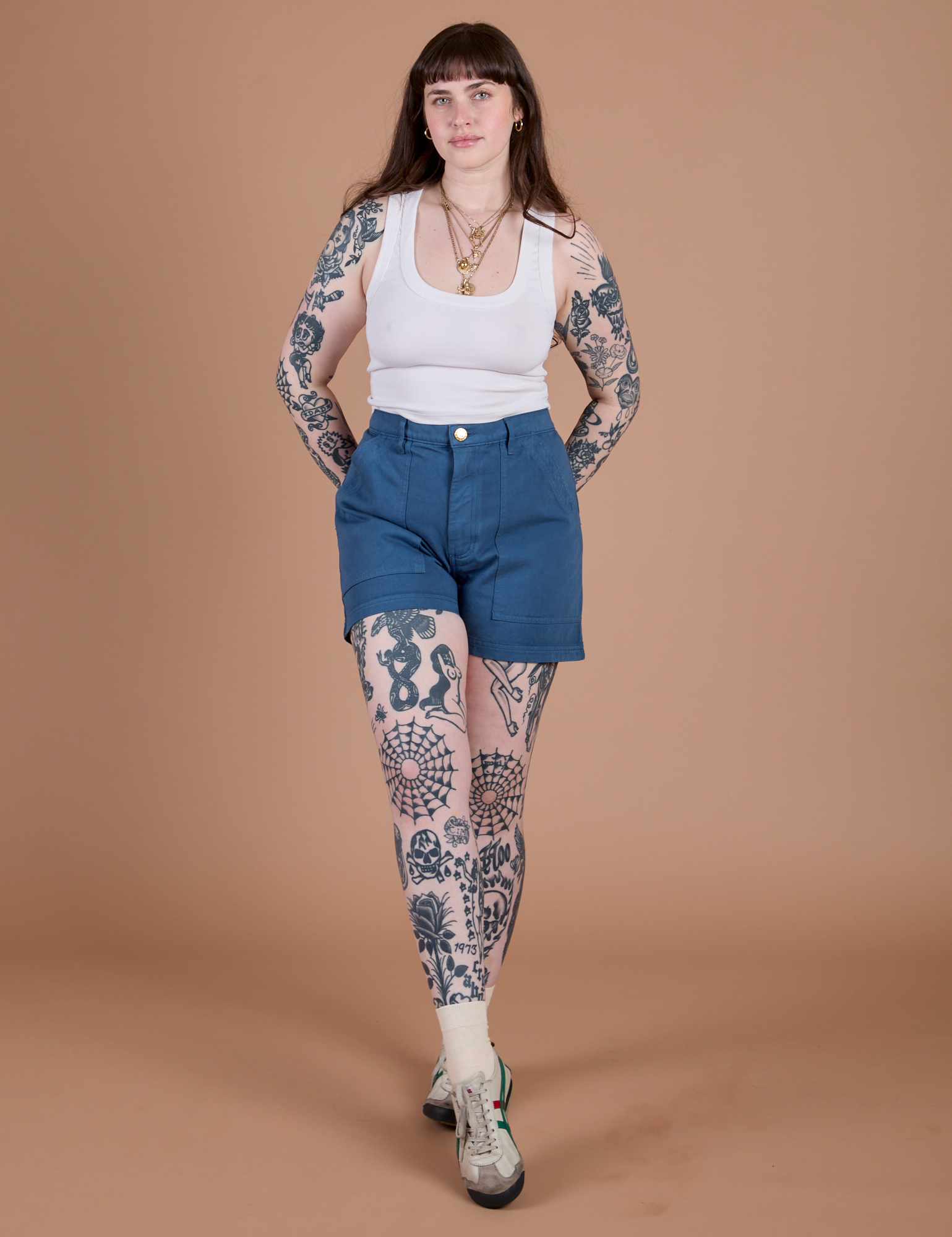 Sydney is 5’9” and wearing M Classic Work Shorts in French Blue paired with a Cropped Tank in Vintage Tee White