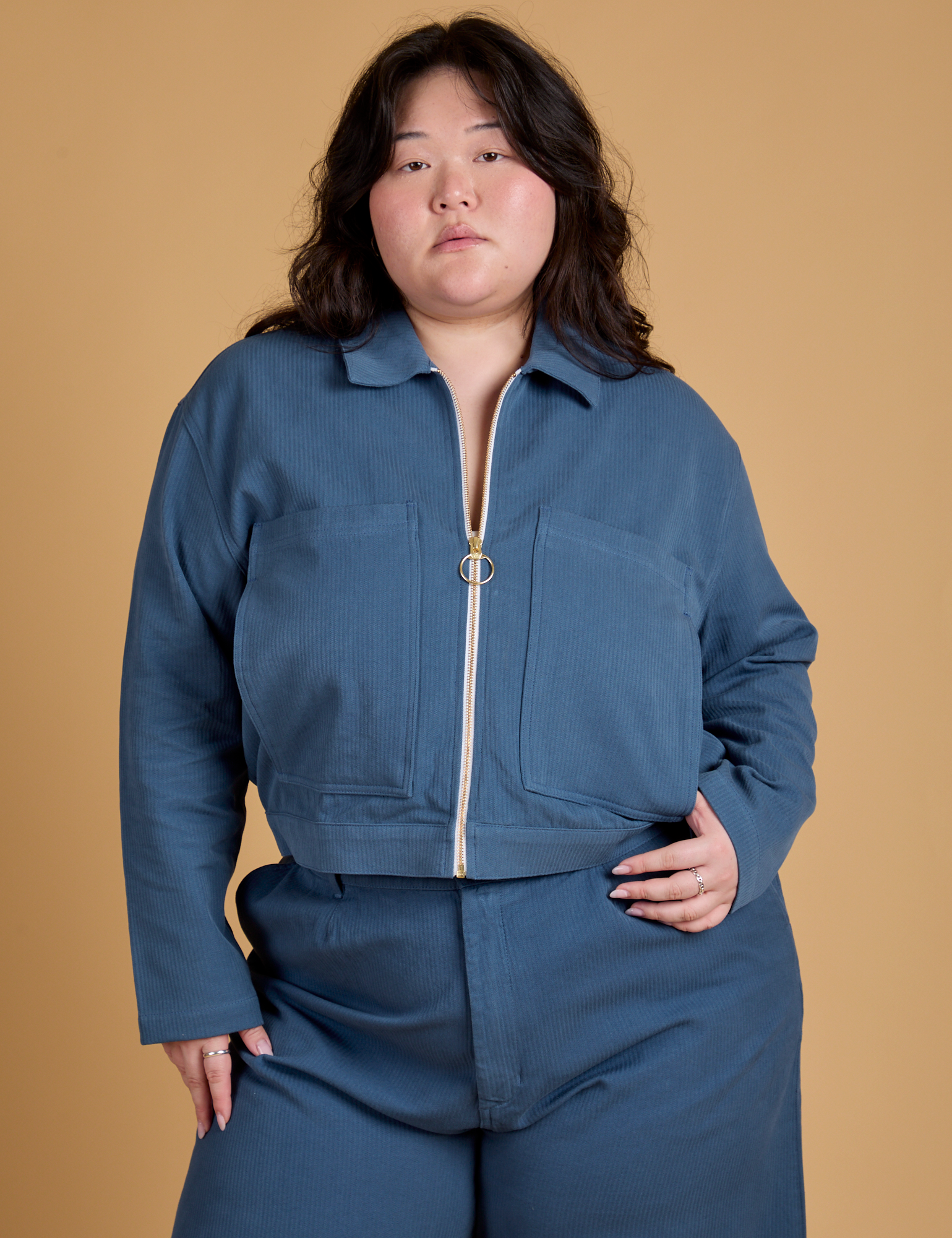 Ashley is wearing a zipped up Heritage Mechanic Jacket in French Blue