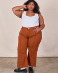 Morgan is 5'5" and wearing 2XL Western Pants in Burnt Terracotta paired with a Cropped Tank in Vintage Tee Off-White