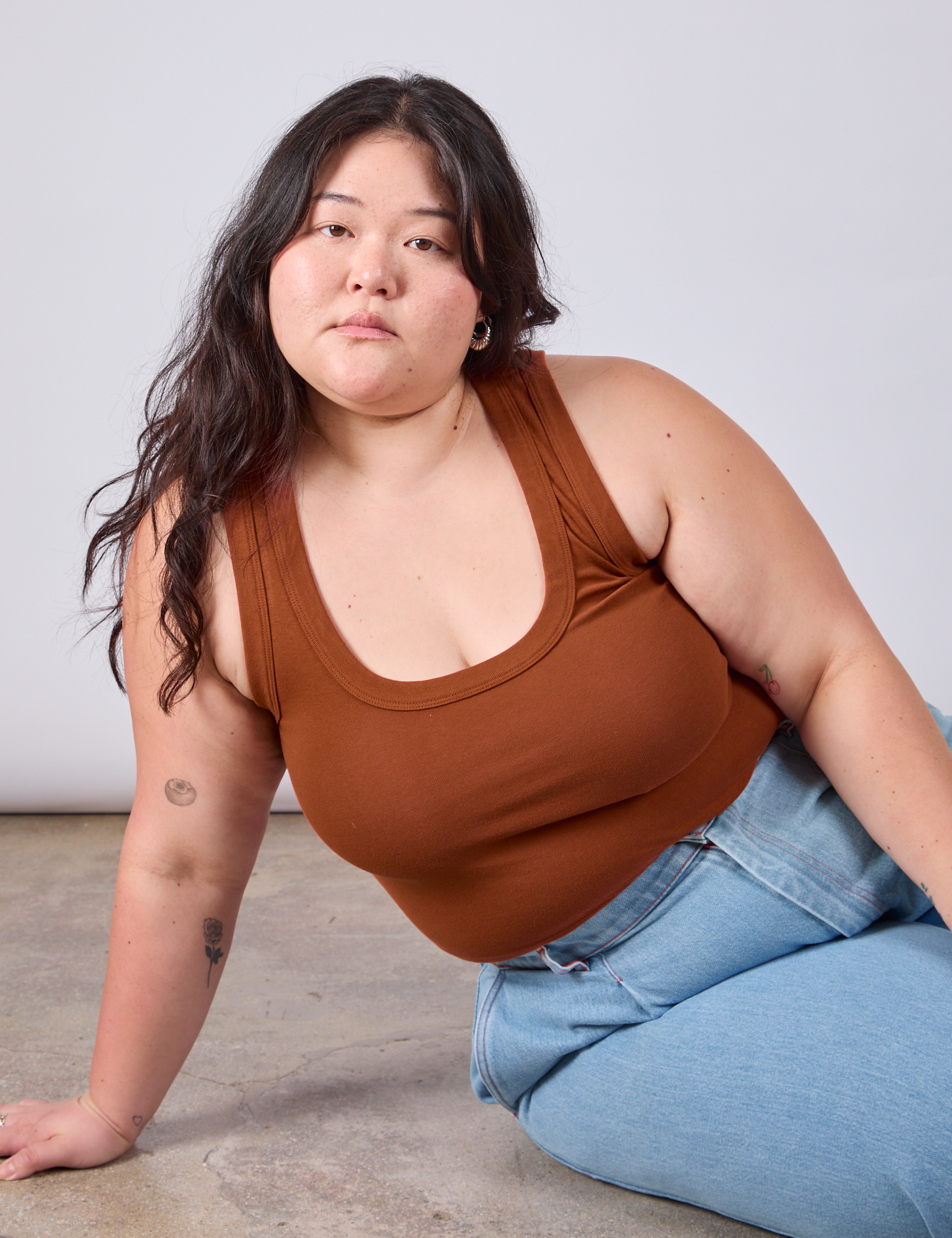 Ashley is wearing Cropped Tank Top in Burnt Terracotta