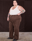 Angled front view of Overdyed Wide Leg Trousers in Brown and vintage off-white Tank Top on Sam