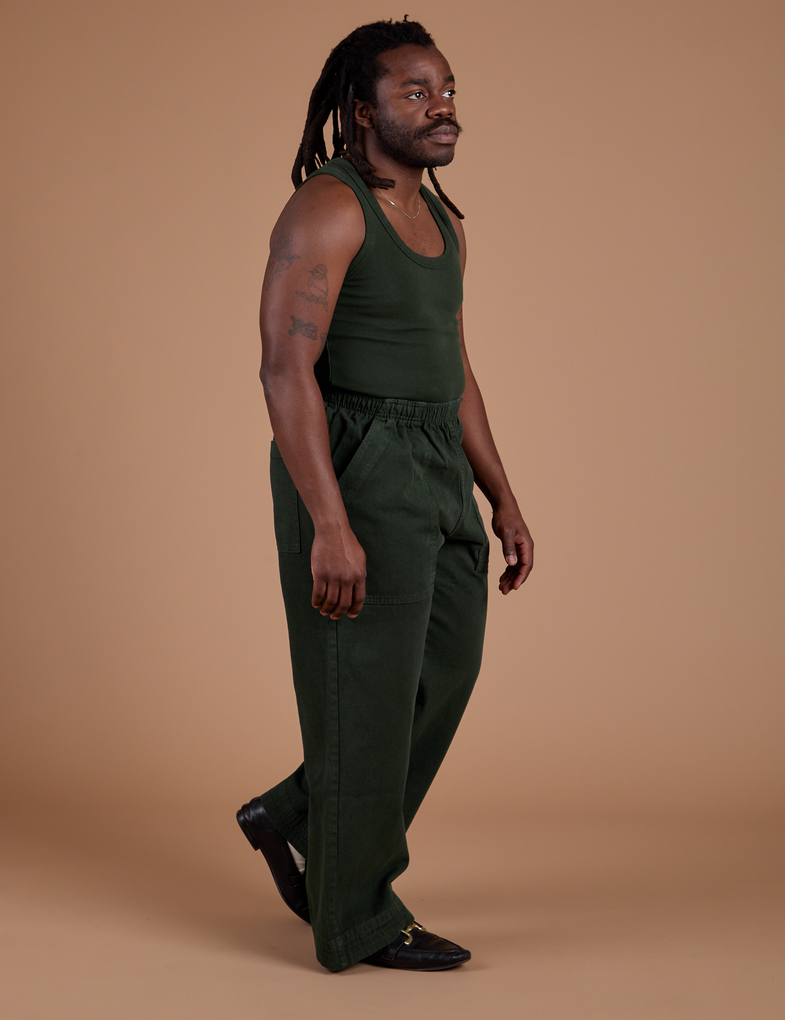 Side view of Action Pants in Swamp Green and Tank Top in Swamp Green on Demi