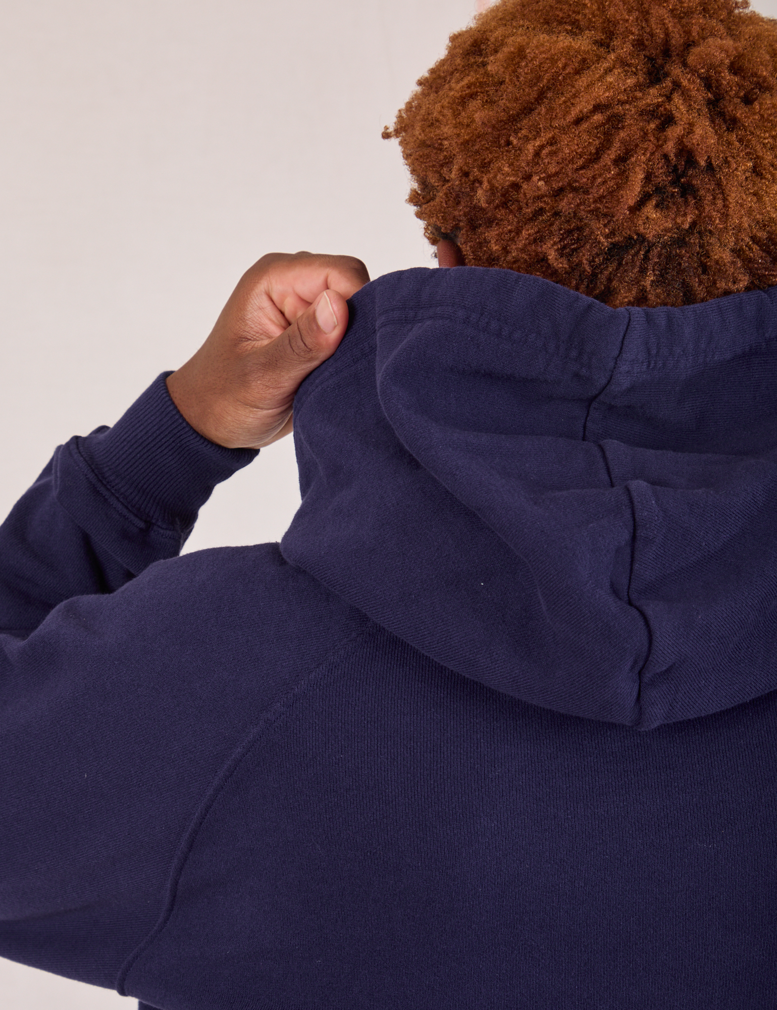 Collegiate Hoodie in Navy Blue back view hood close up on Issac