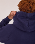 Collegiate Hoodie in Navy Blue back view hood close up on Issac