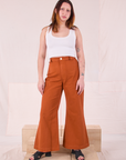 Betty is 5'8" and wearing XS Bell Bottoms in Burnt Terracotta paired with a Cropped Tank in Vintage Tee Off-White