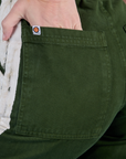 Close up of Alex's hand in the back pocket of Painted Work Pants in Evergreen