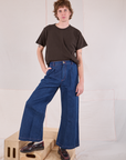 Quinn is wearing Burly Tee in Espresso Brown tucked into dark wash Denim Wide Leg Trousers