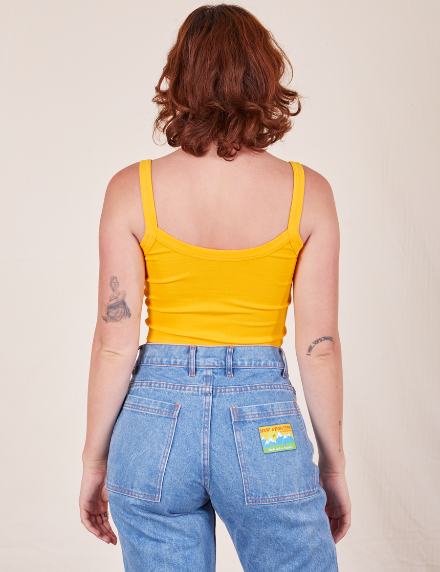 Back view of Cropped Cami in Sunshine Yellow and light wash Frontier Jeans worn by Alex