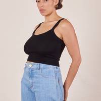 Angled view of Cropped Cami in Basic Black and light wash Sailor Jeans worn by Tiara