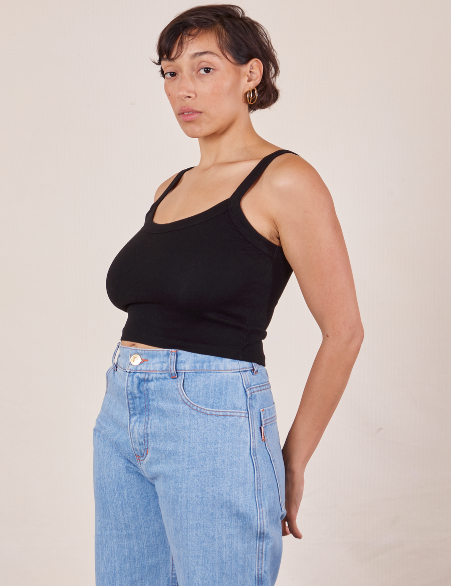 Angled view of Cropped Cami in Basic Black and light wash Sailor Jeans worn by Tiara
