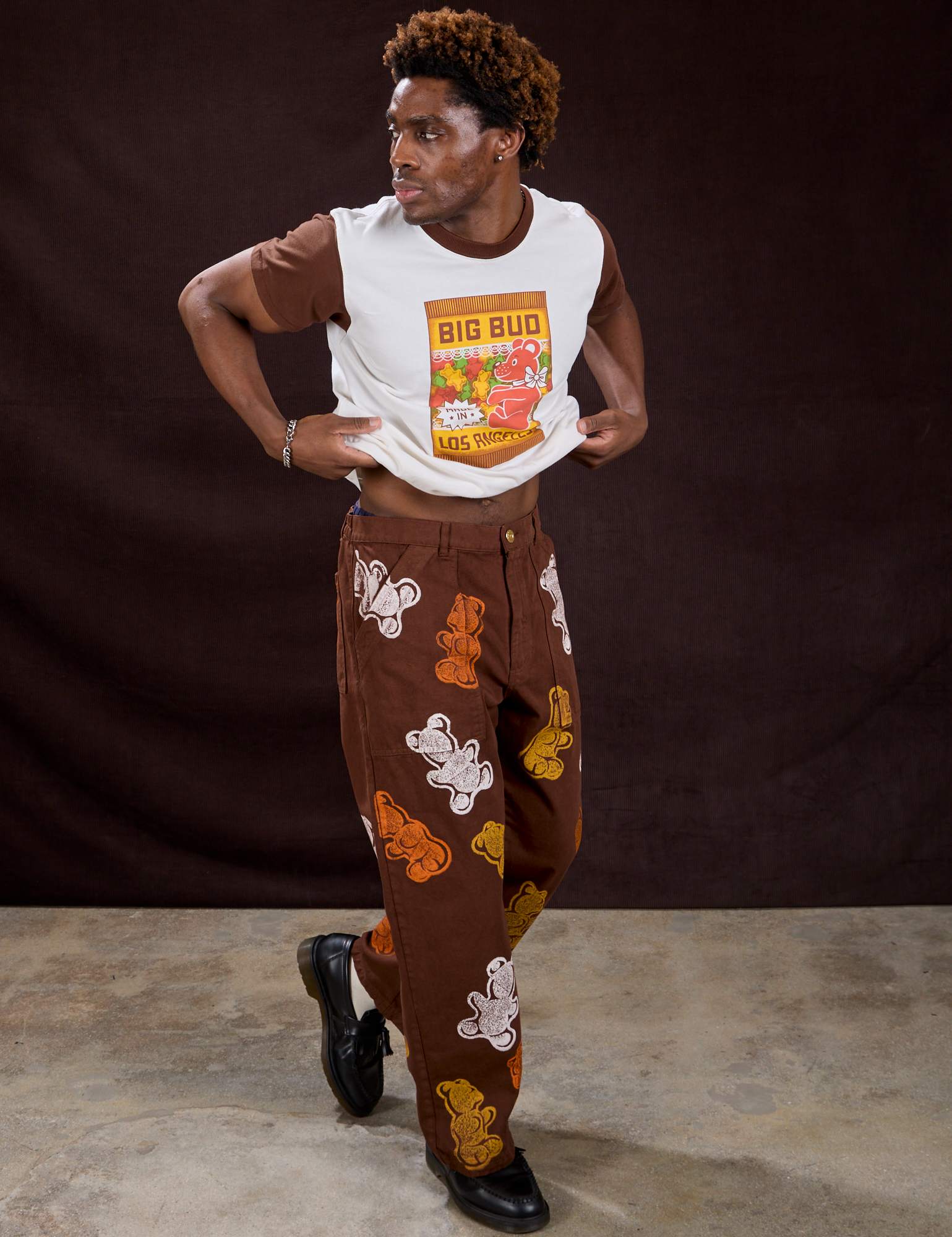 Gummy Bear Paintstamped Work Pants in Fudgesicle Brown and Vintage Tee in Gummy Bear worn by Isaac
