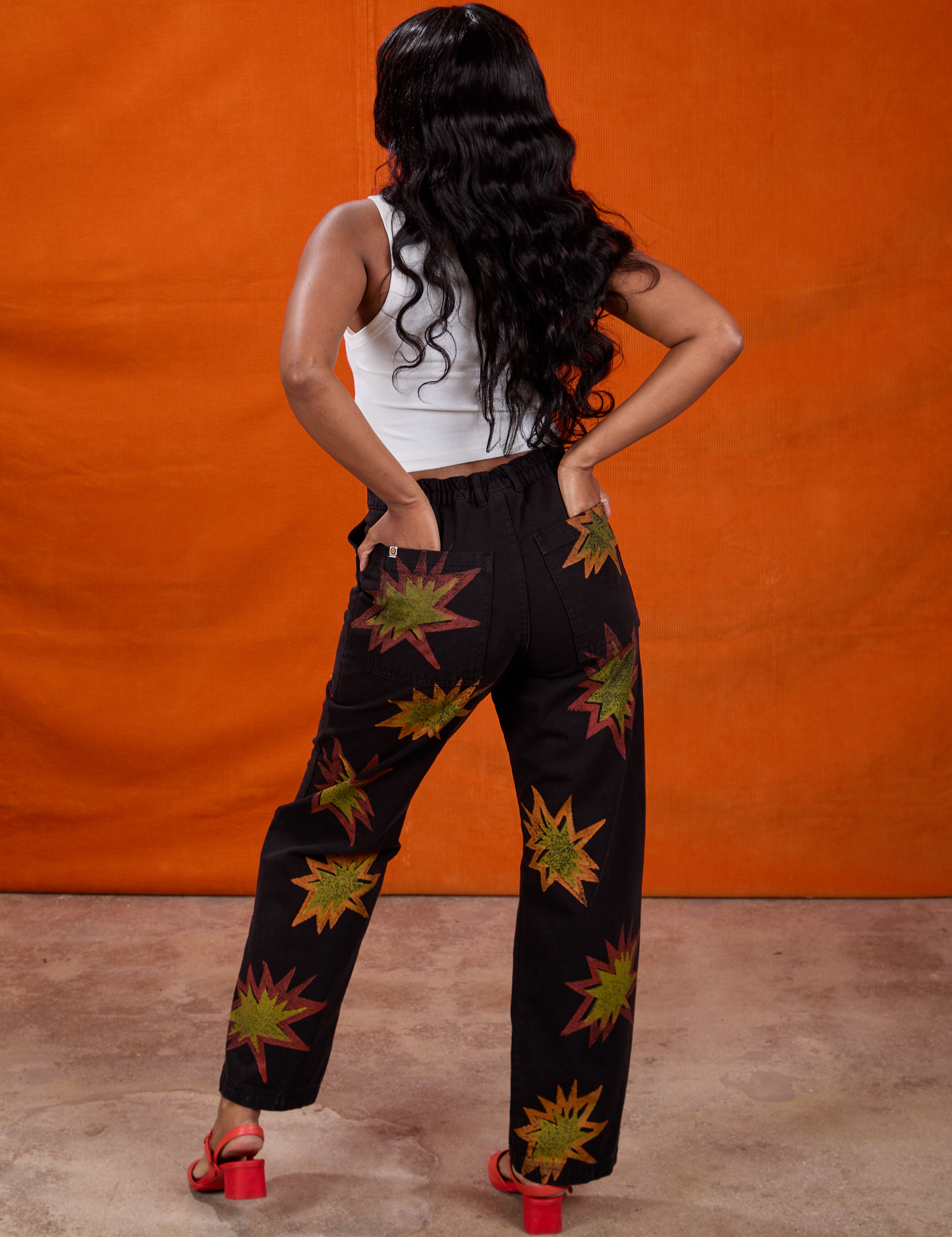 Kandia has both hands in the pocket of Paintstamped Work Pants in Explosion