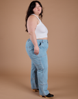 Side view of Carpenter Jeans in Light Wash and Cropped Tank in Vintage Tee White on Ashley