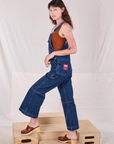 Side view of Carpenter Overalls in Dark Wash on Alex