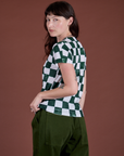 Angled back view of Checker Organic Tee in Swamp Green on Alex