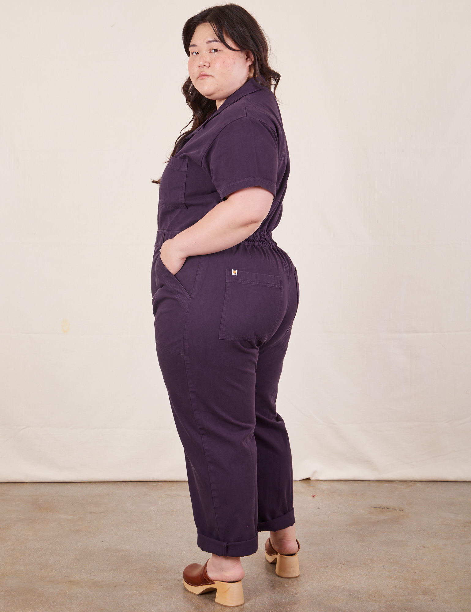 Side view of Short Sleeve Jumpsuit in Nebula Purple worn by Ashley.