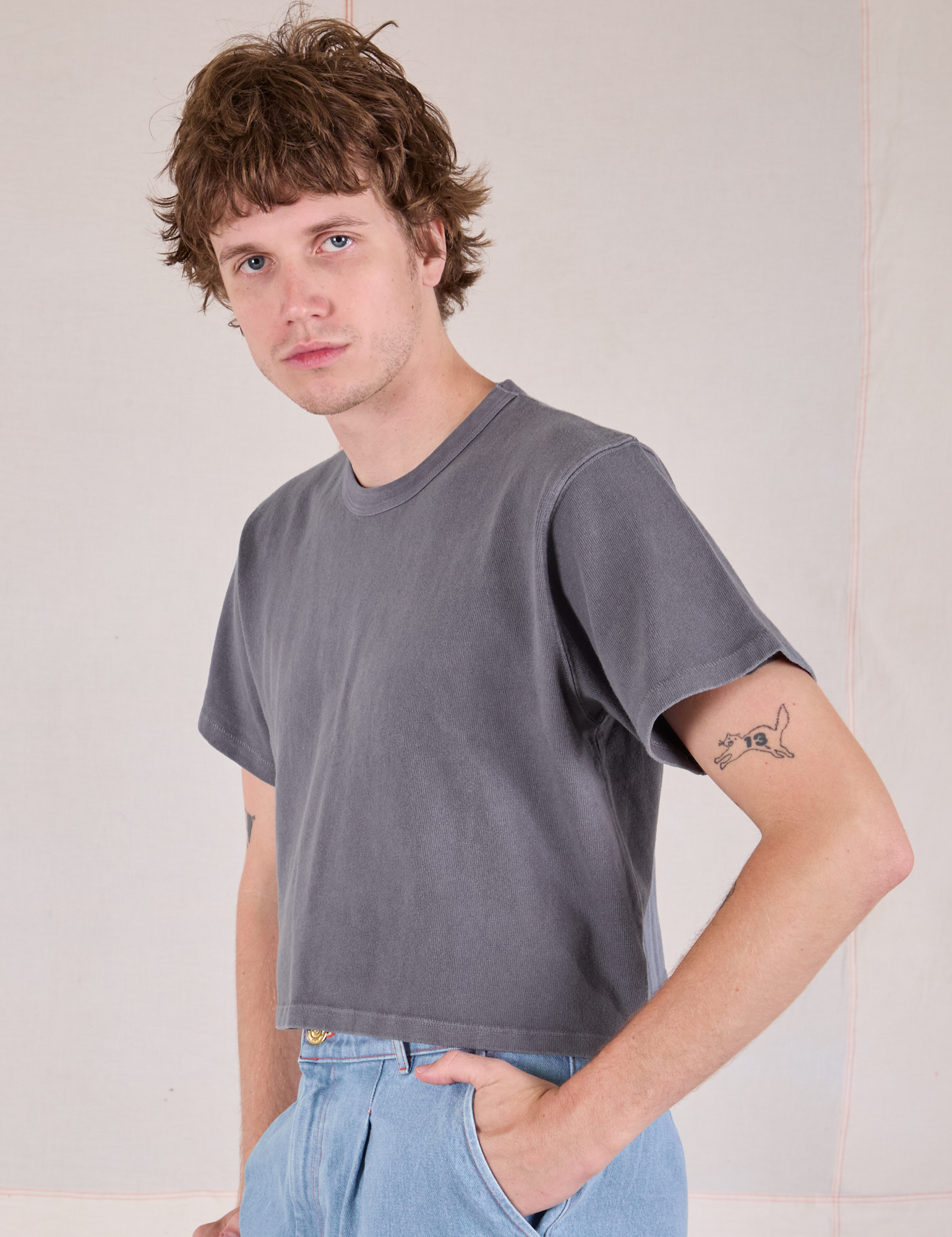 Cropped Burly Tee in Washed Grey angled front view on Quinn