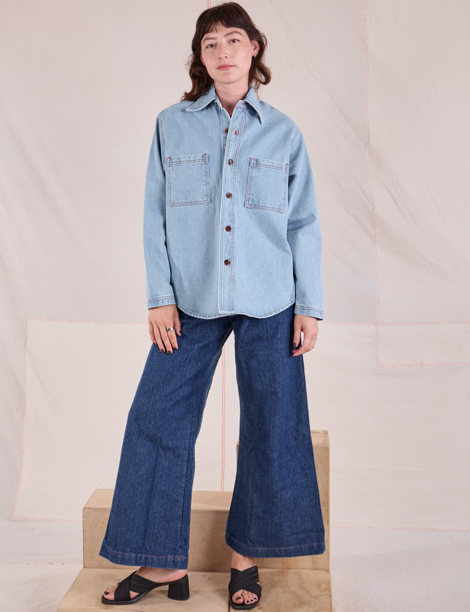 Alex is wearing Denim Overshirt in Light Wash and dark wash Wide Leg Trouser Jeans