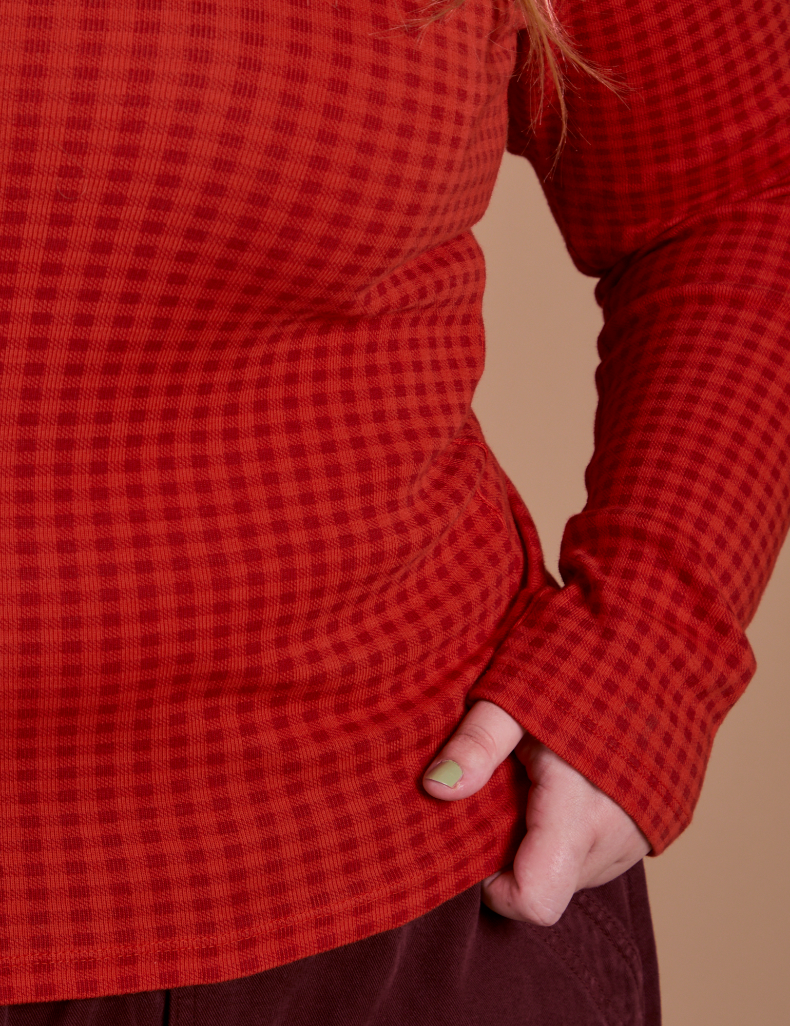 Close up of Gingham Long Sleeve Baby Tee in Mustang Red on Juliet