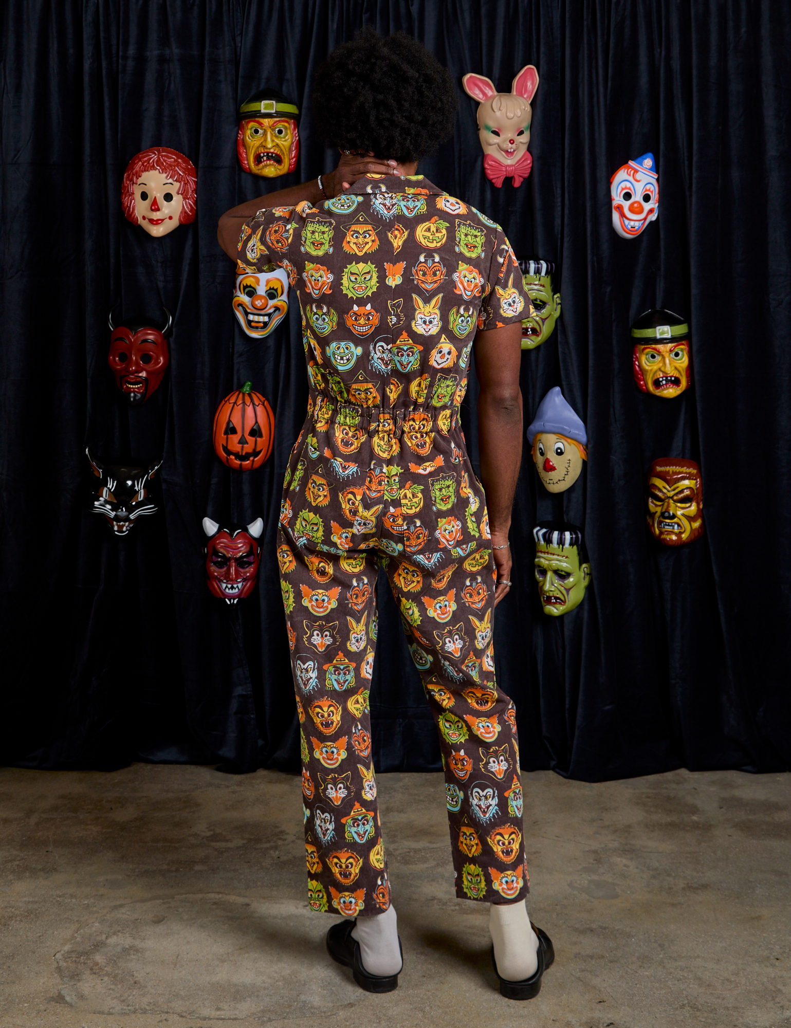 Short Sleeve Jumpsuit in Halloween Masks back view on Jerrod