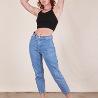 Alex is wearing Halter Top in Basic Black and light wash Frontier Jeans