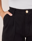 Front close up of Heavyweight Trousers in Basic Black. Tiara has her hand in the pocket.