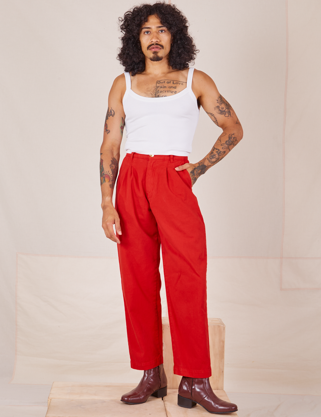Jesse is 5'8" and wearing XXS Heavyweight Trousers in Mustang Red paired with vintage off-white Cropped Cami