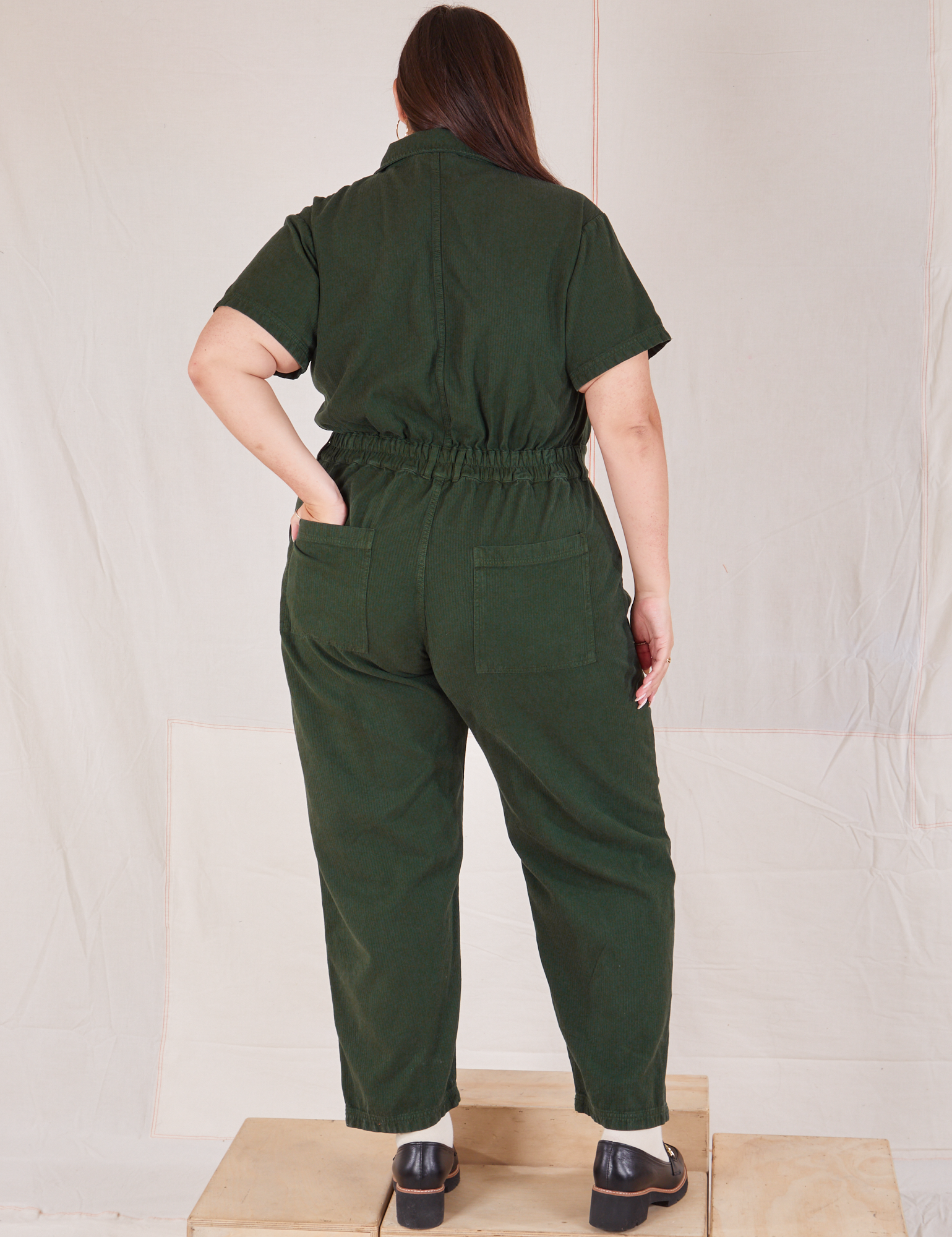 Heritage Short Sleeve Jumpsuit in Swamp Green back view on Katie